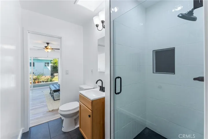 This bathroom has access to the back room / primary.