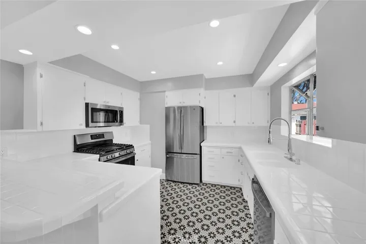 All Newer GE Appliances, Custom Tile Floors, Newer Fixtures, Lighting, Paint, Knobs and Pulls.