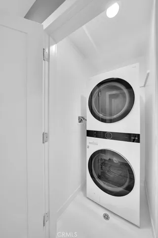 Dedicated Laundry Closet w/ Newer Stackable Washer/Dryer.