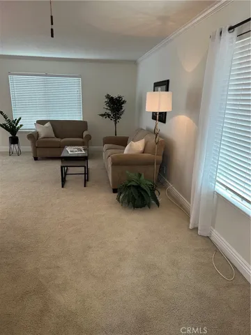 Living room has beige carpeting