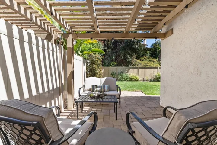 Covered Patio for entertainment, with new pavers and new fence, accessible from the Family Room and Kitchen.