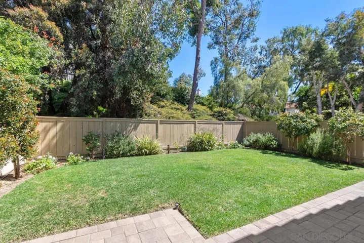 The fully fenced private back yard in the rear of the property is adjacent to the common green belt which provides shade, enhanced breezes and full privacy.
