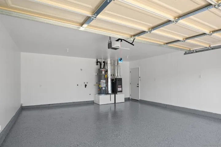 Very clean garage with finished walls and epoxied floors.  Brand new garage door opener, FAU and Water Heater too!