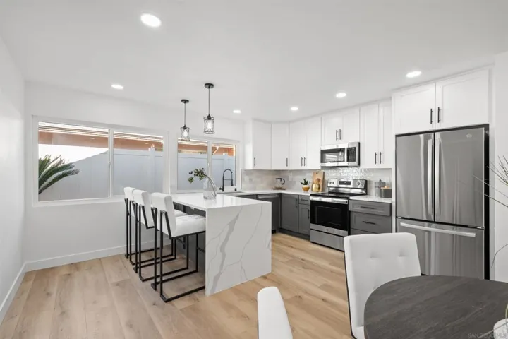 There is also a breakfast bar with beautiful waterfall edge quartz countertops.