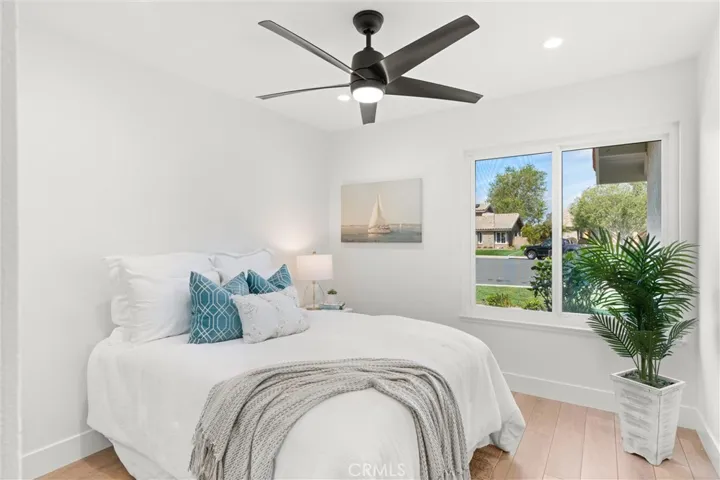This full sized downstairs bedroom (#2) has a double door mirrored closet, recessed lighting & ceiling fan.