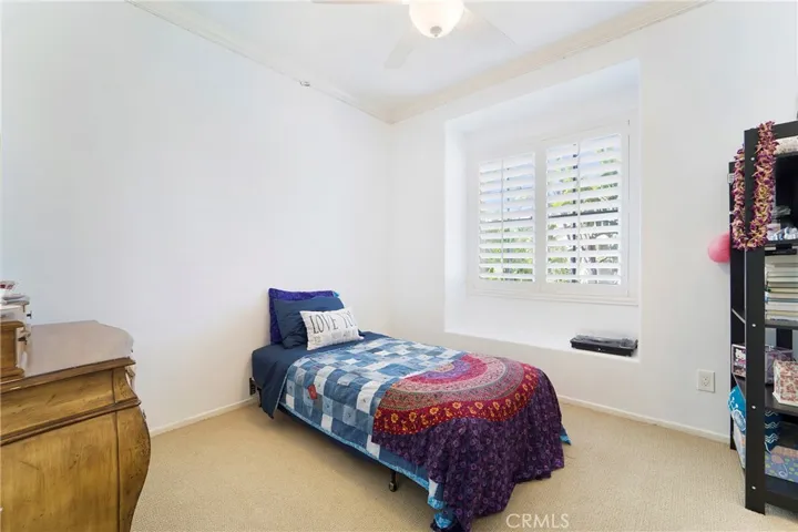 This terrific secondary bedroom includes a window seat and a walk in closet.