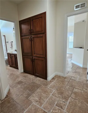 hallway, storage, door to hall bath and primary suite
