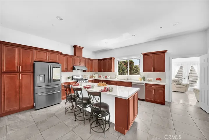 Chef's Gourmet Kitchen with Quartz Countertops, Center Island with Seating, Cherry-Colored Cabinetry, Stainless Appliances