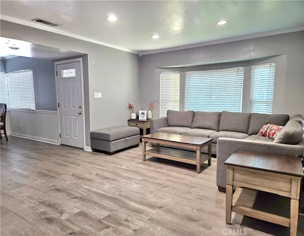 living room, view of front door and dining area to left