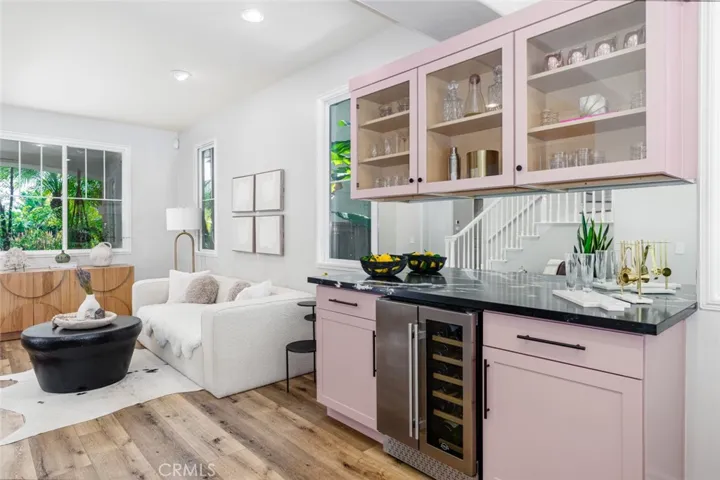 Custom built-in bar with quartz counter top and mini-fridge