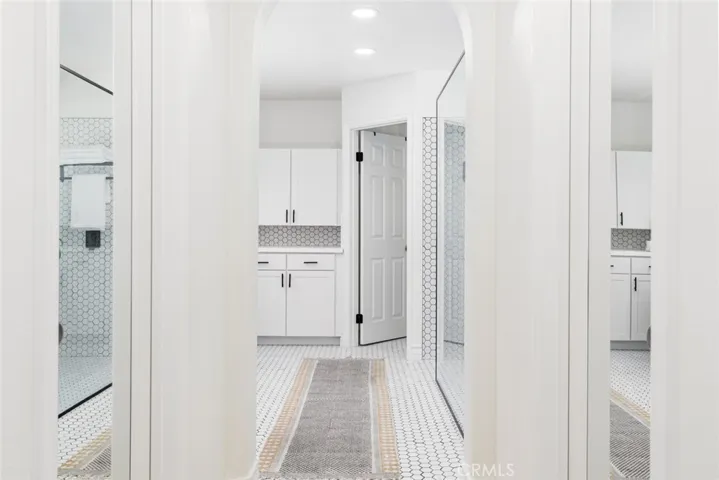 Entry into the master bathroom, with two walk-in closets