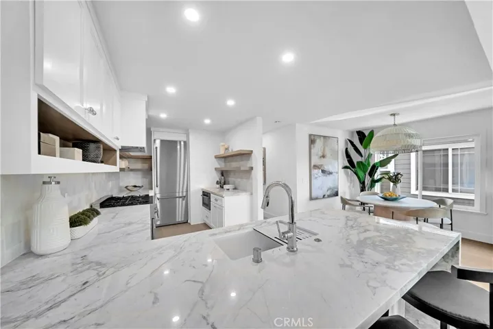 KITCHEN WITH STAINLESS APPLIANCES AND GOLD TRIM