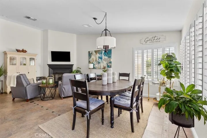 Dining room and family room with wood shutters.l