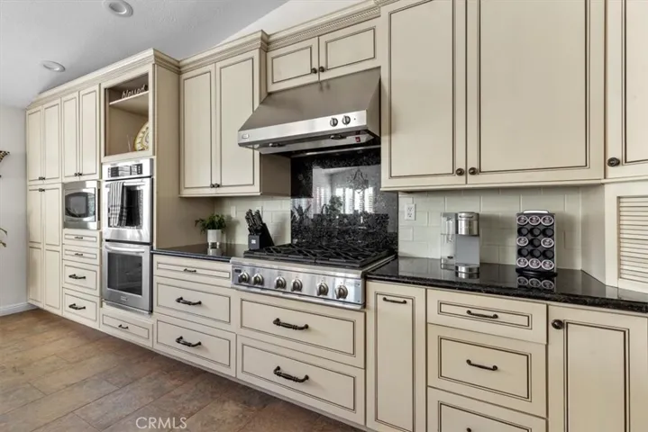 Beautiful kitchen with six burner gas cooktop, double oven and built-in microwave, not to mention, storage galore.