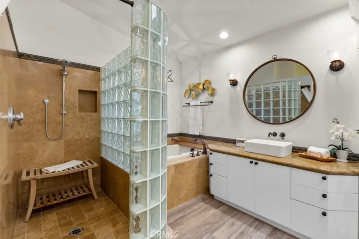 Walk-in shower, separate soaking tub and plenty of storage space.