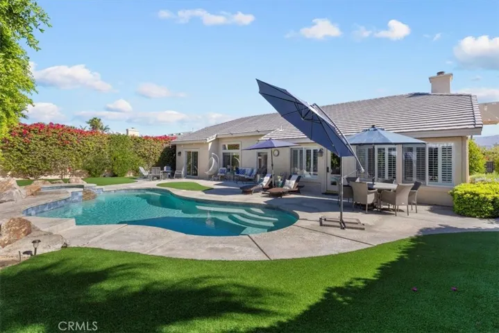 Enjoy the resort style backyard with a jacuzzi that waterfalls into your sparkling pool.