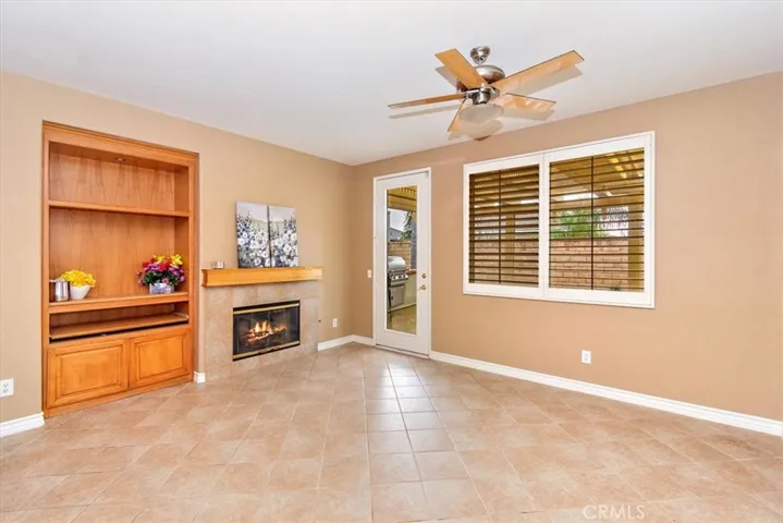 Built in cabinet and a fireplace. Door to the back yard.