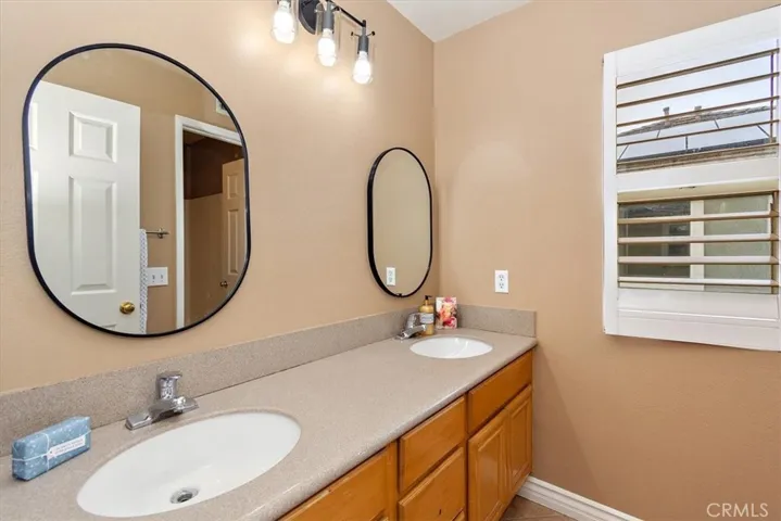 Bathroom has dual sinks.