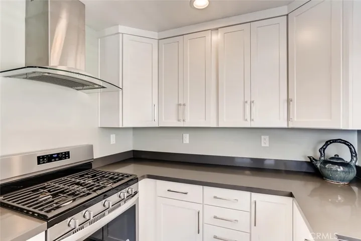 Continuous grate gas range and hood.