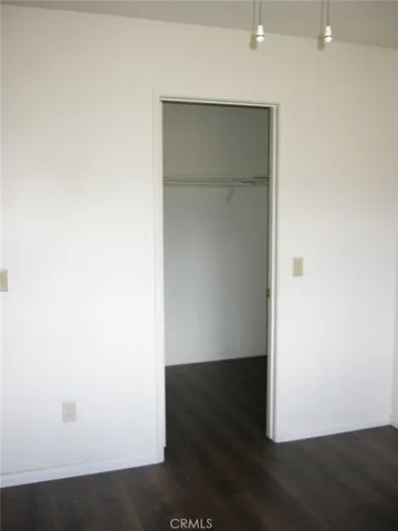 Walk in closet in primary bedroom.