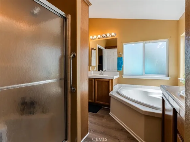 No fighting over counter space with separate vanities and cabinets. There's also a separate soaking tub and full size, low-threshold shower to suit your preference.
