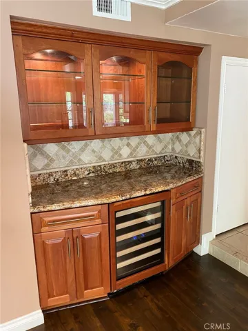 Custom bar area with Kitchen Aid wine fridge.