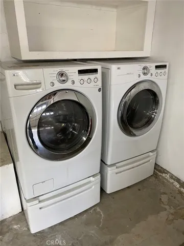 LG washer & dryer along with ample storage in garage.