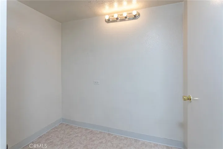 Previously a 3/4 bathroom, the area is now used for storage. The light bar shows where the sink was previously located. To the left of the sink was a toilet  straight in front of the toilet on the other side was a shower.  All the plumbing was capped off in 2012, but is still in place for easy ADU conversion!