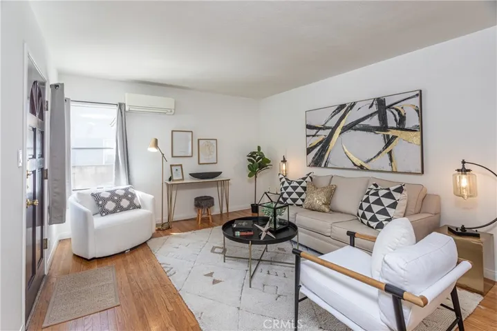 Enter into this welcoming bright and airy open living room with hardwood floors, and smooth ceilings!