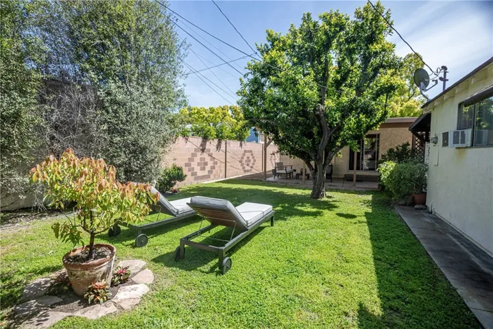 Decorative block wall adds to the rear yard charm! Check out all the greenery = privacy!
