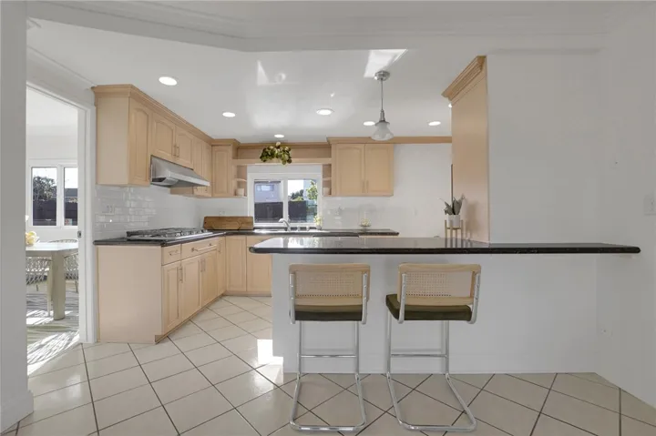 Open kitchen with bar bench seating.