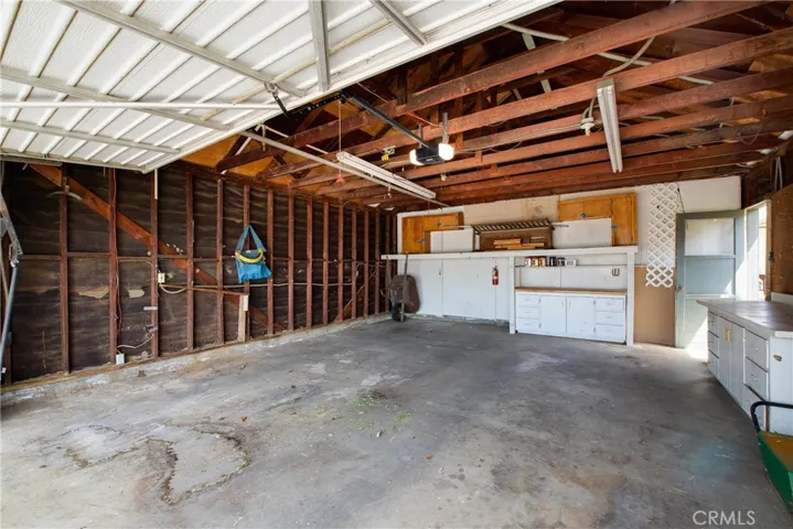 Garage with cabinetry.