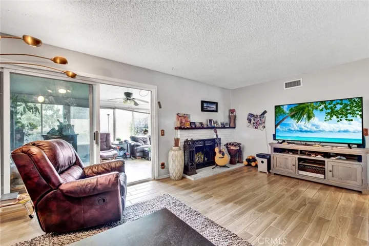 Living room With Slider To Enclosed Patio