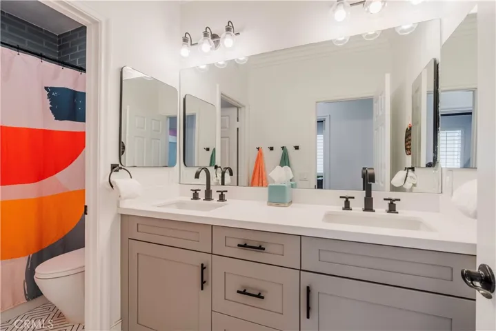 Secondary bathroom with dual sinks ~