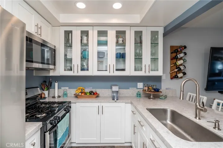 Beautiful details in this completely remodeled home.  The kitchen features a new dishwasher, refrigerator, gas range, built in microwave, sink, lighting and beautiful cabinetry and countertop!