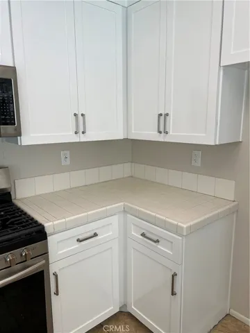White tile counter tops in kitchen