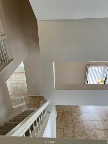 Upstairs looking downstairs to dining/living room on the right and family room to the left.