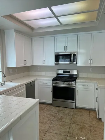 Kitchen with shaker cabinets, new gas range.