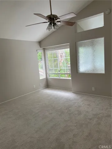 Primary suite with new carpet & ceiling fan.