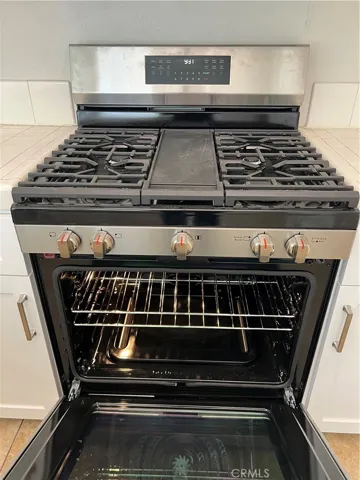 New gas range, microwave oven above range.