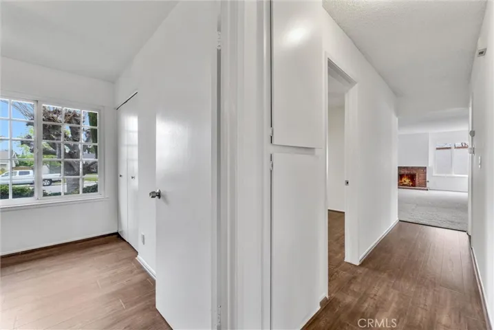 hallway looking toward living room. Two bedrooms on the left.