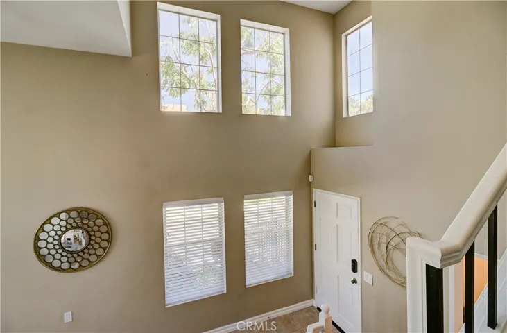 Entry way with cathedral ceilings & gorgeous windows allowing light with privacy!