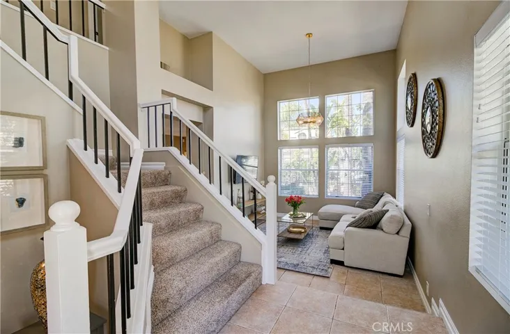 Entry way looking up the sweeping staircase, into the living room.