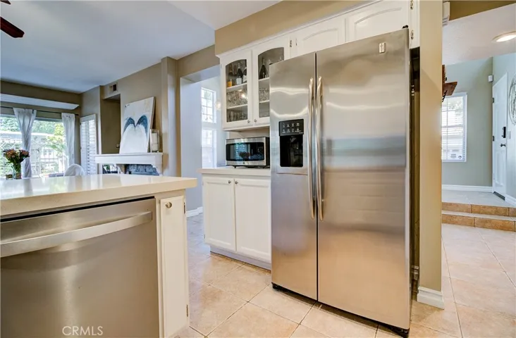 Open kitchen with upgraded stainless steel appliances.  notice the hall to the right - leading to the front entry.  Floor plan is so open