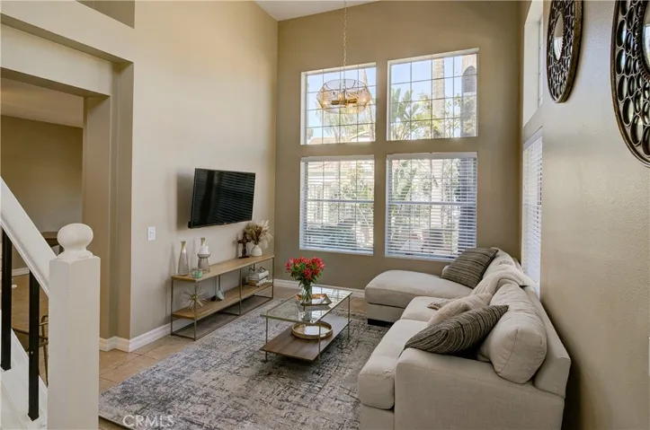 Entry looking into living room. Notice the cathedral ceiling & floor to ceiling windows!