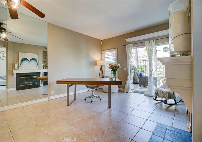 Family room / dining area. Open & bright with a cozy fireplace. Leads out to private back patio.
