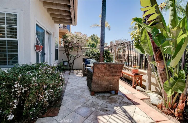 Back patio.  Beautifully hardscaped with plenty of greenery & space.