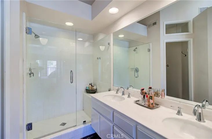 Upgraded, large shower with sparkling glass shower doors & bench for sitting & holding items.