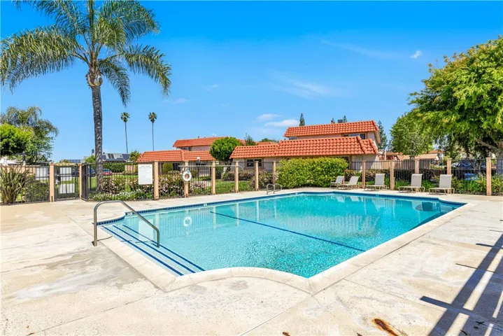 Large community pool with lounging chairs and spa.