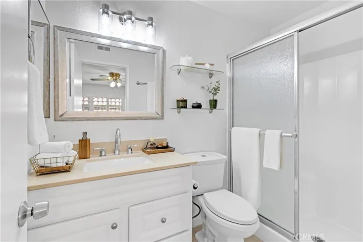 Primary bathroom with upgraded vanity, new shower enclosure, new medicine cabinet, new lighting fixture, faucet, shelving,...